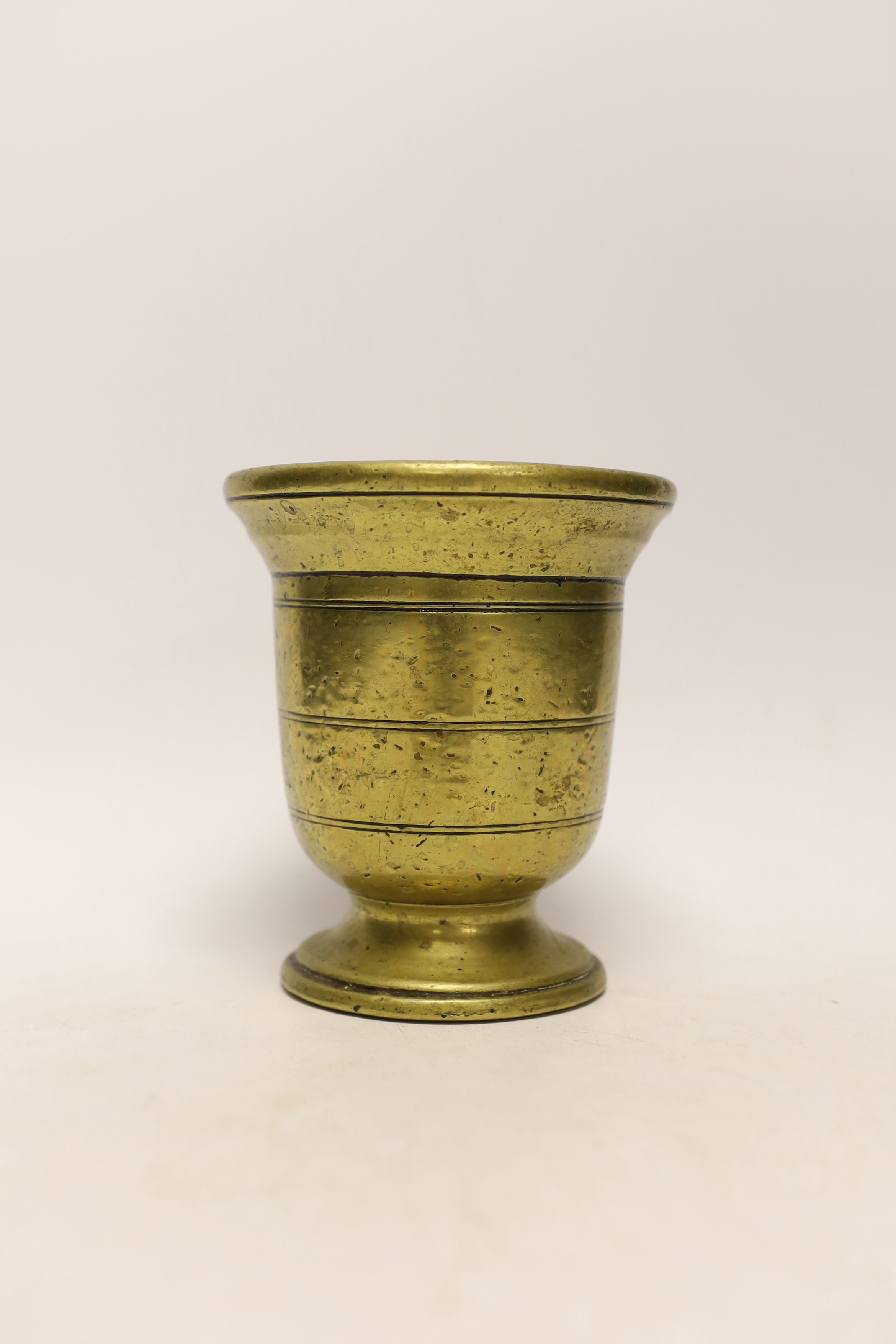 An antique bronze pestle and mortar, 15cm high